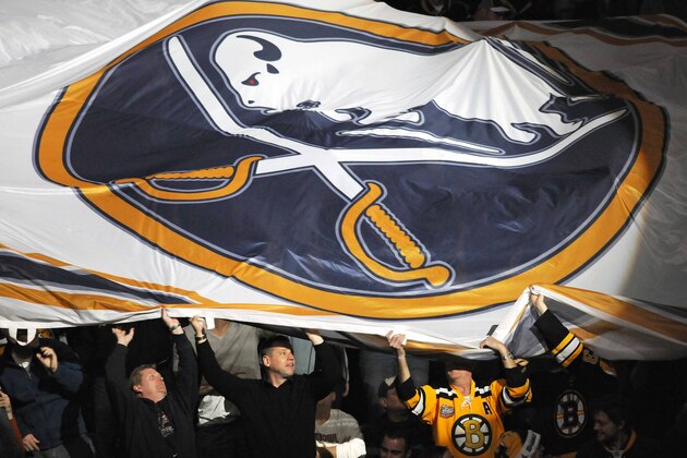 Boston Bruins fans assist in passing around a large Buffalo Sabres logo banner before the first period of an NHL hockey game in Buffalo, N.Y. on Saturday, Jan. 1, 2011. (AP Photo/Don Heupel)
