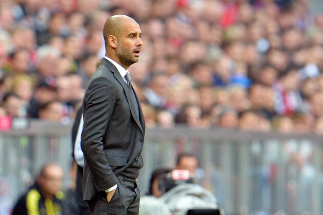 Bayern head coach Pep Guardiola looks on prior to the Bundesliga soccer match between FC Bayern Munich and Borussia Dortmund in Munich, Germany, on Saturday, April 12, 2014. (AP Photo/Kerstin Joensson)