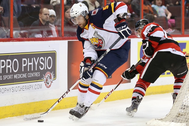 OTTAWA, ON - MARCH 13:  Aaron Ekblad #5 of the Barrie Colts skates with the puck past Travis Konecny #17 of the Ottawa 67's during an OHL game at Canadian Tire Centre on March 13, 2014 in Ottawa, Ontario, Canada.  (Photo by Jana Chytilova/Freestyle Photography/Getty Images)