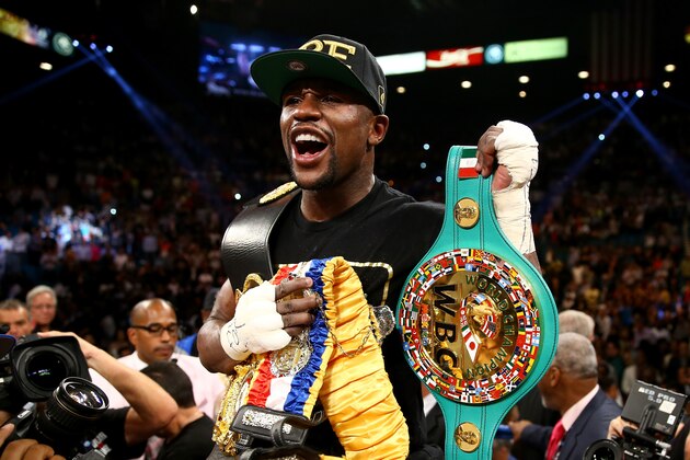 LAS VEGAS, NV - SEPTEMBER 14:  Floyd Mayweather Jr. celebrates his majority decision victory against Canelo Alvarez in their WBC/WBA 154-pound title fight at the MGM Grand Garden Arena on September 14, 2013 in Las Vegas, Nevada.  (Photo by Al Bello/Getty Images)