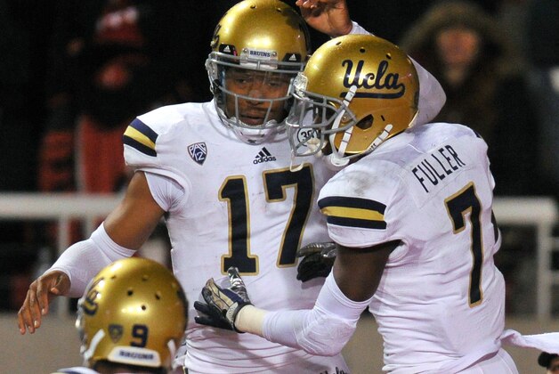 SALT LAKE CITY UT - OCTOBER 3:  Quarterback Brett Hundley #17 of UCLA celebrates with teammates Devin Fuller #7 and Jordan Payton #9 after his game deciding 4th quarter touchdown at Rice- Eccles Stadium October 3, 2013 in Salt Lake City, Utah. UCLA took the win 34-27 over Utah. (Photo by Gene Sweeney Jr/Getty Images)