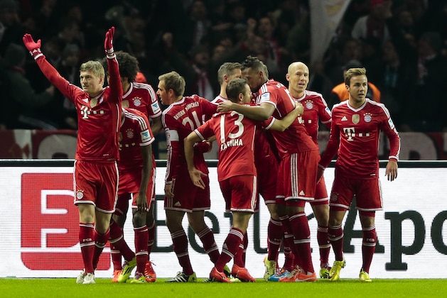 Bayern's Toni Kroos, left, celebrates with the team after scoring his side's first goal during the first division Bundesliga soccer match between Hertha BSC and FC Bayern Munich in Berlin, Tuesday, March 25, 2014. (AP Photo/Markus Schreiber)