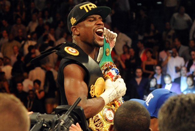Sep 14, 2013; Las Vegas, NV, USA; Floyd Mayweather Jr. celebrates after defeating Canelo Alvarez by a majority decision at their WBC and WBA super welterweight titles fight at MGM Grand Garden Arena. Mandatory Credit: Jayne Kamin-Oncea-USA TODAY Sports