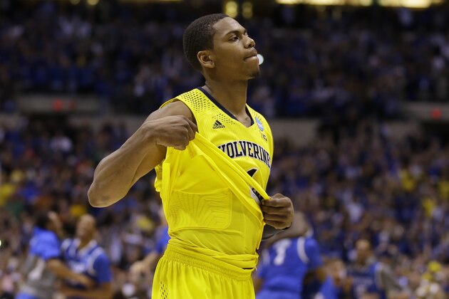 Michigan's Glenn Robinson III walks off the court as Kentucky players celebrate after an NCAA Midwest Regional final college basketball tournament game Sunday, March 30, 2014, in Indianapolis. Kentucky won 75-72 to advance to the Final Four. (AP Photo/Michael Conroy) Michigan's Glenn Robinson III walks off the court as Kentucky players celebrate after an NCAA Midwest Regional final college basketball tournament game Sunday, March 30, 2014, in Indianapolis. Kentucky won 75-72 to advance to the Final Four. (AP Photo/Michael Conroy)
