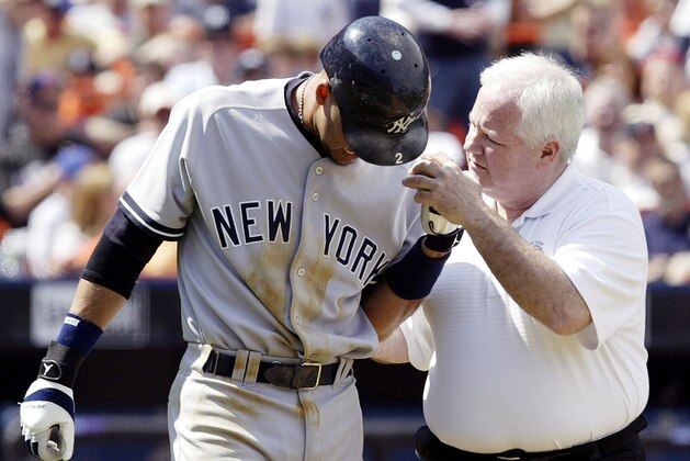 New York Yankees shortstop Derek Jeter grimaces after being hit in the elbow with a pitch in the sixth inning against the New York Mets as he walks with assistant coach Steve Donahue at Shea Stadium in New York Saturday, May21, 2005.  (AP Photo/Gregory Bull)