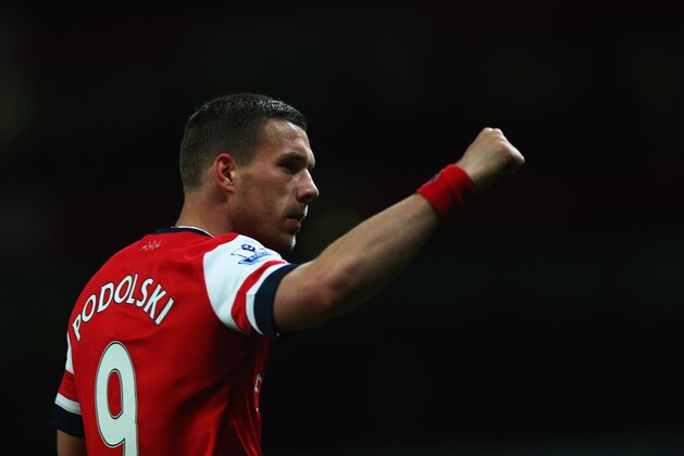 LONDON, ENGLAND - APRIL 15:  Lukas Podolski of Arsenal celebrates as he scores their third goal during the Barclays Premier League match between Arsenal and West Ham United at Emirates Stadium on April 15, 2014 in London, England.  (Photo by Paul Gilham/Getty Images)