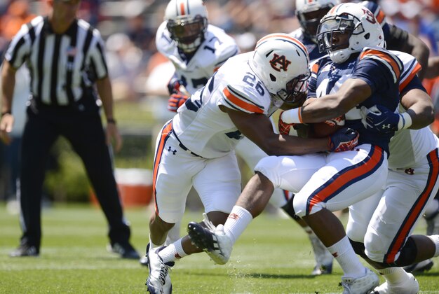 Apr 20, 2013; Auburn, AL, USA; Auburn running back Anthony Swain (44) carries the ball against Auburn linebacker Justin Garrett (26) during their A-Day spring game at Jordan-Hare Stadium. Mandatory Credit: John David Mercer-USA TODAY Sports