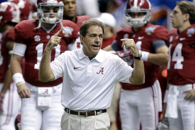 FILE - In this file photo from Jan. 2, 2014, Alabama head coach Nick Saban, center, calls drills as his team warms up before the NCAA college football Sugar Bowl against Oklahoma in New Orleans. The Southeastern Conference is still reigning supreme on the recruiting trail. The Crimson Tide is poised to bring in another top-rated recruiting class on Wednesday's, Feb. 5, 2014, national signing day. Six SEC rivals also have built top 10 classes, according to the 247Sports composite rankings of the major recruiting sites. (AP Photo/Rusty Costanza, File)