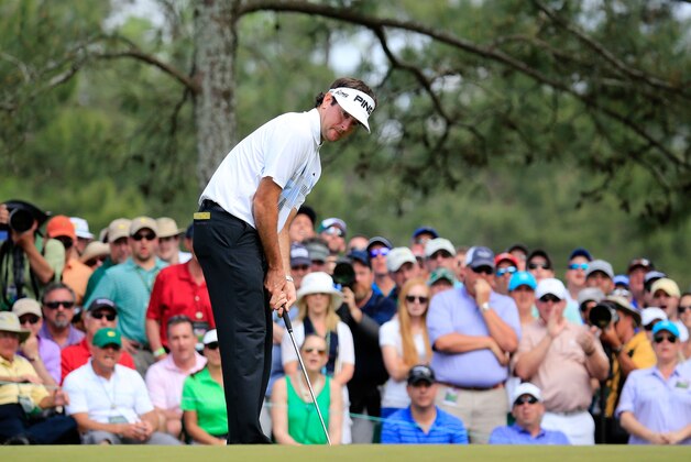AUGUSTA, GA - APRIL 13:  Bubba Watson of the Unted States putts on the sixth green as a gallery of patrons look on during the final round of the 2014 Masters Tournament at Augusta National Golf Club on April 13, 2014 in Augusta, Georgia.  (Photo by Rob Carr/Getty Images)