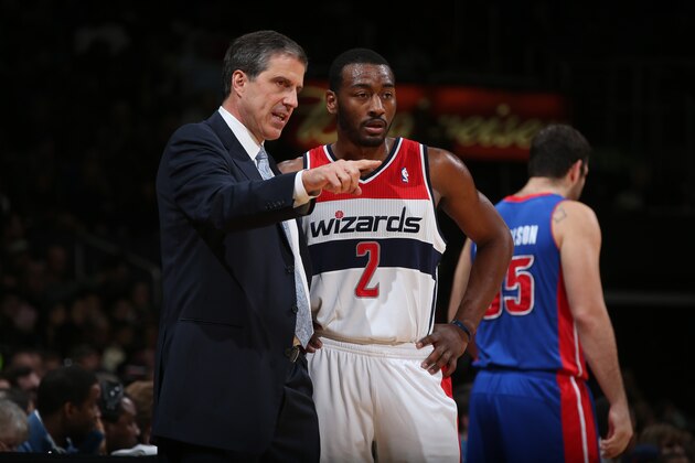 Washington Wizards guard John Wall listens to head coach Randy Wittman in the second half of an NBA basketball game against the Miami Heat, Monday, April 14, 2014, in Washington. The Wizards won 114-93. (AP Photo/Alex Brandon)