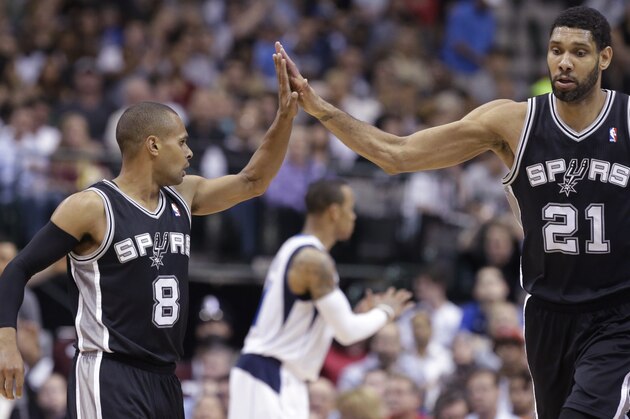 San Antonio Spurs guard Patty Mills (8) receives congratulations from Tim Duncan (21) during the second half an NBA basketball game against the Dallas Mavericks on Thursday, April 10, 2014, in Dallas. The Spurs won 109-100. (AP Photo/LM Otero)