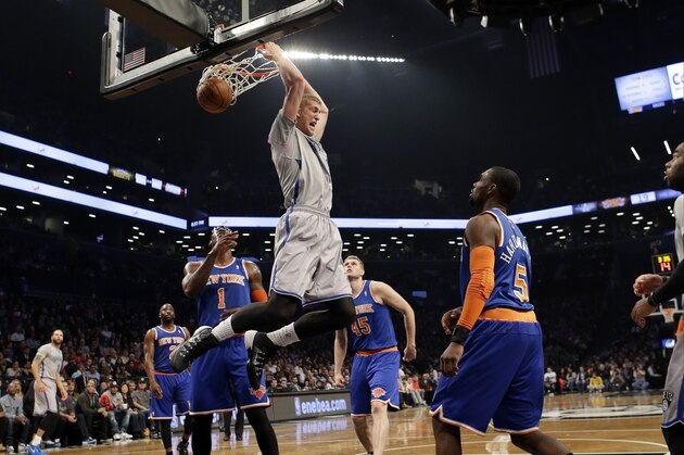 Brooklyn Nets' Mason Plumlee (1) dunks in front of New York Knicks' Tim Hardaway Jr. (5) during the first half of an NBA basketball game Tuesday, April 15, 2014, in New York. (AP Photo/Frank Franklin II)