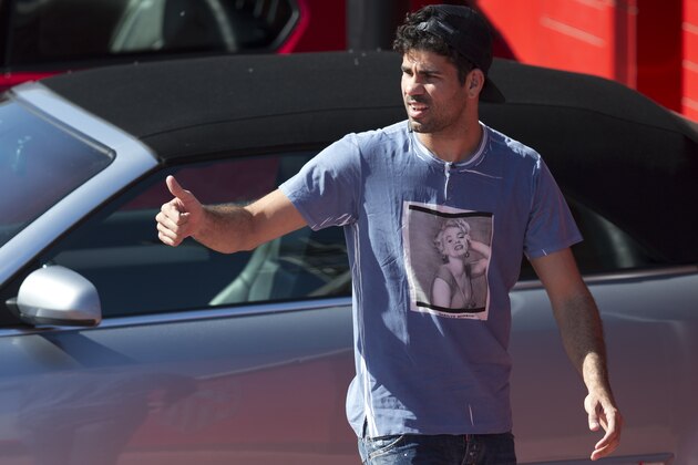 Atletico's Diego Costa arrives at the club's training ground in Madrid, Spain,Tuesday April 8, 2014. Atletico Madrid will play FC Barcelona Wednesday in a 2nd leg, quarterfinal Champions League soccer match in Madrid. (AP Photo/Paul White)
