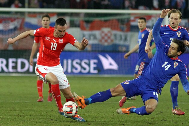 ST GALLEN, SWITZERLAND - MARCH 05: Mate Males of Croatia (R) challenges Josip Drmic of Switzerland (L) during the international friendly match between Switzerland and Croatia at the AFG Arena on March 5, 2014 in St Gallen, Switzerland.  (Photo by Marc Eich/Getty Images)