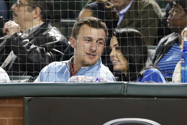 Apr 15, 2014; Arlington, TX, USA; Johnny Manziel sits front row to watch the Texas Rangers play against the Seattle Mariners at Globe Life Park in Arlington. The Rangers beat the Mariners 5-0. Mandatory Credit: Matthew Emmons-USA TODAY Sports
