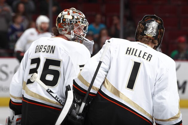 VANCOUVER, BC - APRIL 7: John Gibson #36, preparing to start his first NHL game, talks to veteran Jonas Hiller #1 of the Ducks  before facing off against the Vancouver Canucks at Rogers Arena April 7, 2014 in Vancouver, British Columbia, Canada.  (Photo by Jeff Vinnick/NHLI via Getty Images)
