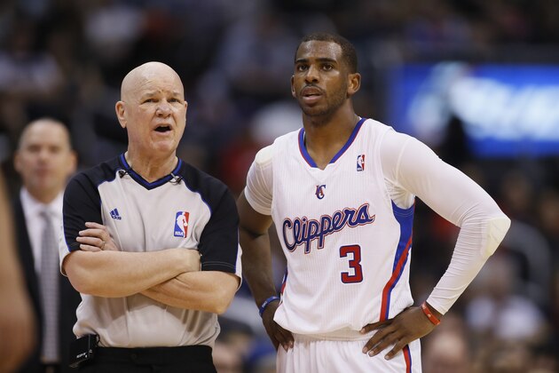 NBA referee Joey Crawford talks on the court with Los Angeles Clippers guard Chris Paul during the NBA basketball game between the Sacramento Kings and Los Angeles Clippers in Los Angeles, Saturday, April 12, 2014. The Clippers won 117-101. (AP Photo/Danny Moloshok)