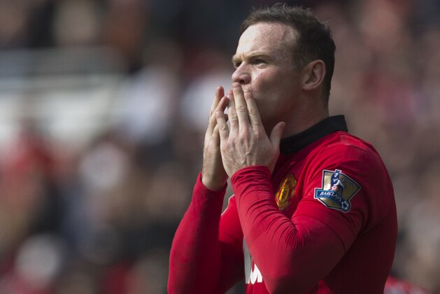 Manchester United's Wayne Rooney celebrates after scoring a penalty against Aston Villa, during their English Premier League soccer match at Old Trafford Stadium, Manchester, England, Saturday March 29, 2014. (AP Photo/Jon Super)