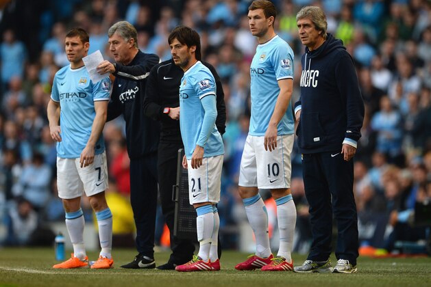 MANCHESTER, ENGLAND - MARCH 09: Manchester City manager Manuel Pellegrini brings on James Milner, David Silva and Edin Dzeko during the 2nd half of the FA Cup Quarter-Final match between Manchester City and Wigan Athletic at the Etihad Stadium on March 9, 2014 in Manchester, England.  (Photo by Michael Regan/Getty Images)