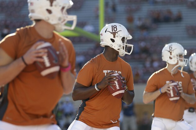 Texas' Tyrone Swoopes (18) goes through warmups with teammates David Ash, left, and Case McCoy (6) prior to an NCAA college football game against Kansas State, Saturday,  Sept. 21, 2013, in Austin, Texas. (AP Photo/Eric Gay)
