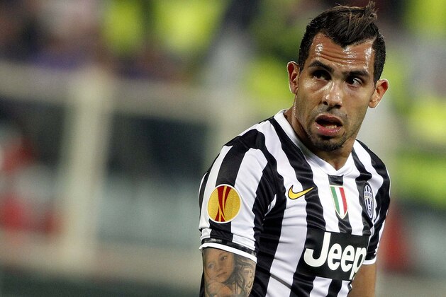 Juventus' Carlos Tevez  walks on the pitch during an Europa League, round of 16, return-leg soccer  match between Fiorentina and Juventus at the Artemio Franchi stadium in Florence, Italy, Thursday, March 20, 2014. (AP Photo/Fabrizio Giovannozzi)