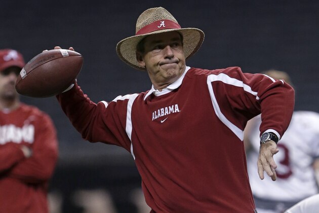 Alabama head coach Nick Saban throws a football during NCAA college football practice at the Superdome in New Orleans, Saturday, Dec. 28, 2013.  Alabama takes on Oklahoma in the Sugar Bowl on Thursday, Jan. 2, 2014. (AP Photo/Gerald Herbert)