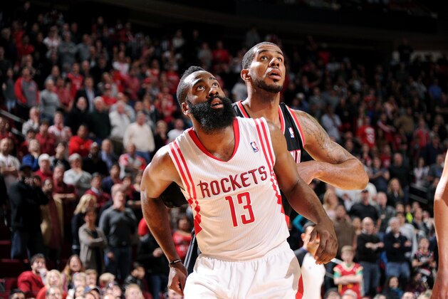 HOUSTON, TX - MARCH 9:  James Harden #13 of the Houston Rockets battles for position against LaMarcus Aldridge #12 of the Portland Trail Blazers on March 9, 2014 at the Toyota Center in Houston, Texas. NOTE TO USER: User expressly acknowledges and agrees that, by downloading and or using this photograph, User is consenting to the terms and conditions of the Getty Images License Agreement. Mandatory Copyright Notice: Copyright 2014 NBAE (Photo by Bill Baptist/NBAE via Getty Images)