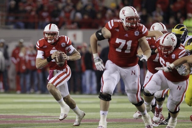 In this Oct. 27, 2012, photo, Nebraska quarterback Taylor Martinez (3) carries the ball behind Jeremiah Sirles (71) and Spencer Long (61) in an NCAA college football game against Michigan in Lincoln, Neb. UCLA plays at Nebraska on Sept. 14. The Bruins made a statement early last season in Los Angeles by beating the Cornhuskers 36-30. Quarterback Brett Hundley and the Bruins put up 653 yards against Nebraska. Now the Bruins come to Lincoln with the Huskers looking for payback and with one of the most versatile and dynamic offenses in the country, led Martinez. (AP Photo/Nati Harnik) In this Oct. 27, 2012, photo, Nebraska quarterback Taylor Martinez (3) carries the ball behind Jeremiah Sirles (71) and Spencer Long (61) in an NCAA college football game against Michigan in Lincoln, Neb. UCLA plays at Nebraska on Sept. 14. The Bruins made a statement early last season in Los Angeles by beating the Cornhuskers 36-30. Quarterback Brett Hundley and the Bruins put up 653 yards against Nebraska. Now the Bruins come to Lincoln with the Huskers looking for payback and with one of the most versatile and dynamic offenses in the country, led Martinez. (AP Photo/Nati Harnik)