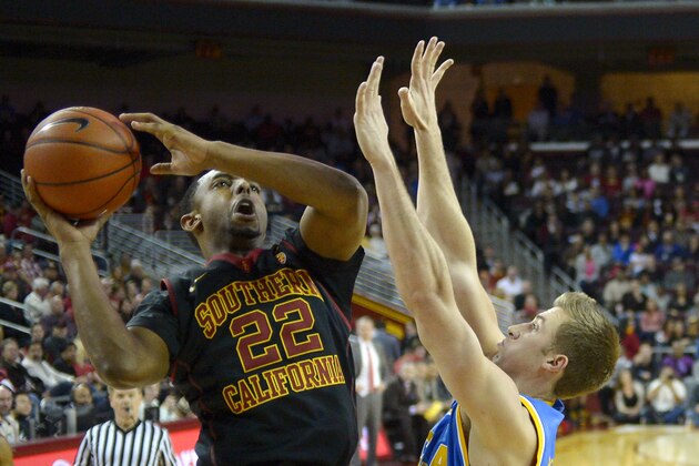 Southern California guard Byron Wesley, left, goes up for a shot as UCLA forward David Wear defends during the first half of an NCAA college basketball game, Saturday, Feb. 8, 2014, in Los Angeles. (AP Photo/Mark J. Terrill)