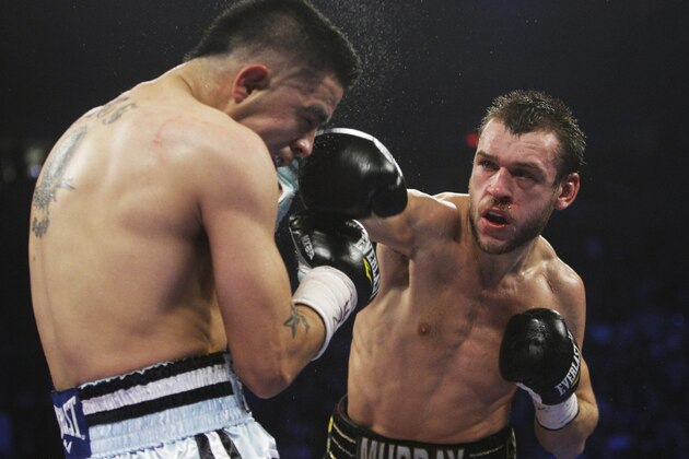 Britain's John Murray, right, punches Brandon Rios during the fourth round of an WBA World Lightweight Championship boxing match Saturday, Dec. 3, 2011  in New York. Murray lost the fight. (AP Photo/Frank Franklin II)