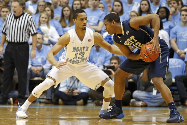 Pittsburgh's Chris Jones (12) is challenged by North Carolina's J.P. Tokoto (13) during the first half of an NCAA college basketball game in Chapel Hill, N.C., Saturday, Feb. 15, 2014. (AP Photo/Karl B DeBlaker) Pittsburgh's Chris Jones (12) is challenged by North Carolina's J.P. Tokoto (13) during the first half of an NCAA college basketball game in Chapel Hill, N.C., Saturday, Feb. 15, 2014. (AP Photo/Karl B DeBlaker)