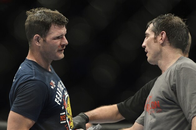 Apr 16, 2014; Quebec City, Quebec, Canada; Michael Bisping (red gloves) shakes hands with Tim Kennedy (blue gloves) after their middleweight bout at Colisee Pepsi. Mandatory Credit: Eric Bolte-USA TODAY Sports