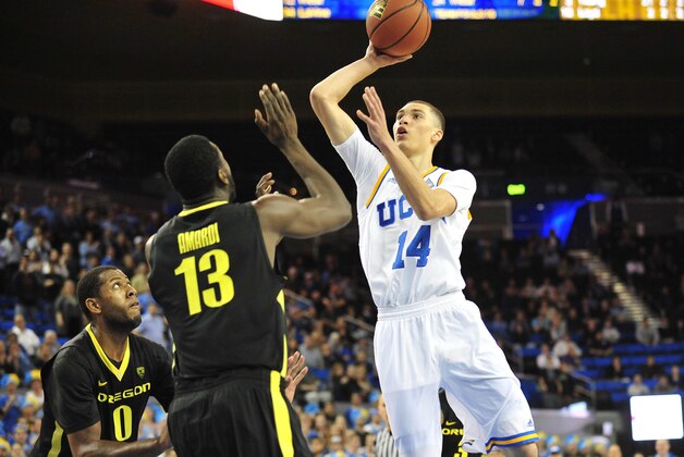 February 27, 2014; Los Angeles, CA, USA; UCLA Bruins guard Zach LaVine (14) shoots against Oregon Ducks forward Richard Amardi (13) and guard Mike Moser (0) during the second half at Pauley Pavilion. Mandatory Credit: Gary A. Vasquez-USA TODAY Sports