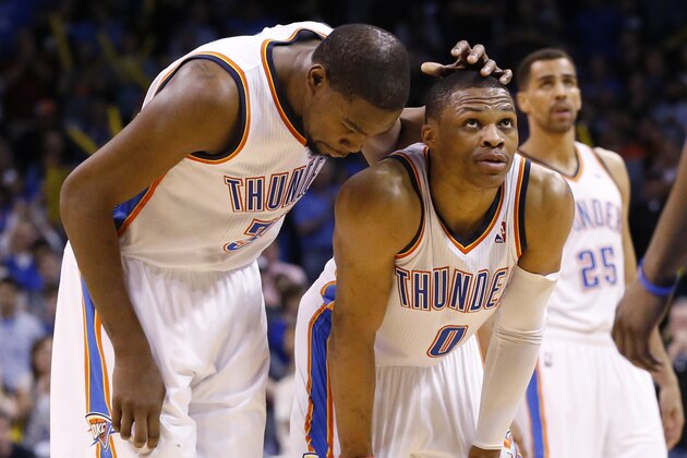 Oklahoma City Thunder forward Kevin Durant (35) pats teammate Russell Westbrook on the head as Westbrook prepares to take a foul shot in the fourth quarter of an NBA basketball game against the Detroit Pistons in Oklahoma City, Wednesday, April 16, 2014. Oklahoma City won 112-111. Guard Thabo Sefolosha (25) is at right. (AP Photo/Sue Ogrocki)
