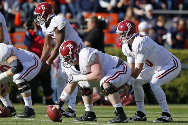 AUBURN, AL - NOVEMBER 30:  AJ McCarron #10 and Chad Lindsay #78 of the Alabama Crimson Tide warm up prior to their game against the Auburn Tigers at Jordan-Hare Stadium on November 30, 2013 in Auburn, Alabama.  (Photo by Kevin C. Cox/Getty Images)