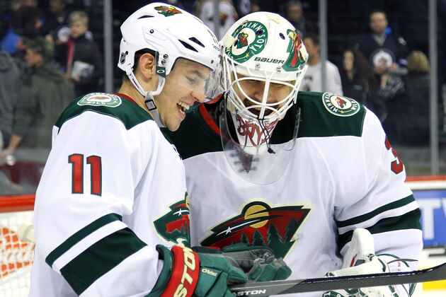 WINNIPEG, MB - APRIL 7:  Zach Parise #11 and goaltender Ilya Bryzgalov #30 of the Minnesota Wild share a laugh following a 1-0 victory over the Winnipeg Jets at the MTS Centre on April 7, 2014 in Winnipeg, Manitoba, Canada. (Photo by Jonathan Kozub/NHLI via Getty Images)