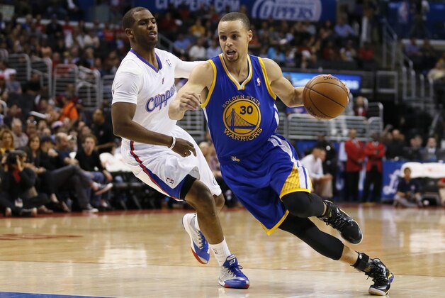 Golden State Warriors' Stephen Curry, right, drives around Los Angeles Clippers' Chris Paul during the first half of an NBA basketball game in Los Angeles, Wednesday, March 12, 2014. (AP Photo/Danny Moloshok)