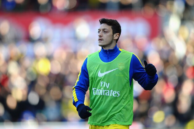 STOKE ON TRENT, ENGLAND - MARCH 01: Mesut Ozil of Arsenal warms up as a substitute  during the Barclays Premier League match between Stoke City and Arsenal at Britannia Stadium on March 1, 2014 in Stoke on Trent, England.  (Photo by Laurence Griffiths/Getty Images)