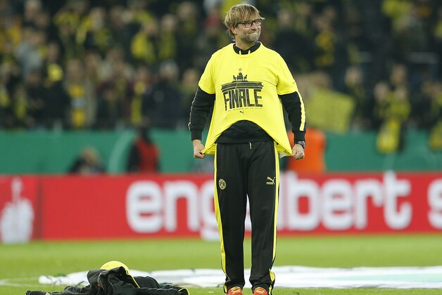 Dortmund head coach Juergen Klopp smiles as he puts on a T-Shirt with the words 'Final', after winning the German soccer cup (DFB Pokal) semifinal match between BvB Borussia Dortmund and VfL Wolfsburg Tuesday, April 15, 2014 in Dortmund, Germany. (AP Photo/Frank Augstein) Dortmund head coach Juergen Klopp smiles as he puts on a T-Shirt with the words 'Final', after winning the German soccer cup (DFB Pokal) semifinal match between BvB Borussia Dortmund and VfL Wolfsburg Tuesday, April 15, 2014 in Dortmund, Germany. (AP Photo/Frank Augstein)