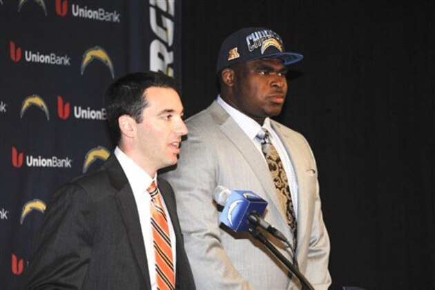 San Diego Chargers general manager Tom Telesco, left, talks about Chargers first round NFL draft pick offensive tackle D.J. Fluker, right, at a news conference held at the Chargers facility Friday, April 26, 2013 in San Diego.  (AP Photo/Denis Poroy)