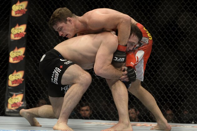 Apr 16, 2014; Quebec City, Quebec, Canada; Michael Bisping (red gloves) fights against Tim Kennedy (blue gloves) during their middleweight bout at Colisee Pepsi. Mandatory Credit: Eric Bolte-USA TODAY Sports