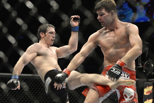 Apr 16, 2014; Quebec City, Quebec, Canada; Michael Bisping (red gloves) fights against Tim Kennedy (blue gloves) during their middleweight bout at Colisee Pepsi. Mandatory Credit: Eric Bolte-USA TODAY Sports