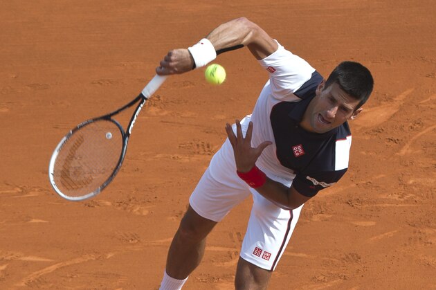 Novak Djokovic of Serbia serves the ball to Albert Montanes of Spain during their match of the Monte Carlo Tennis Masters tournament in Monaco, Tuesday, April 15, 2014. (AP Photo/Michel Euler)