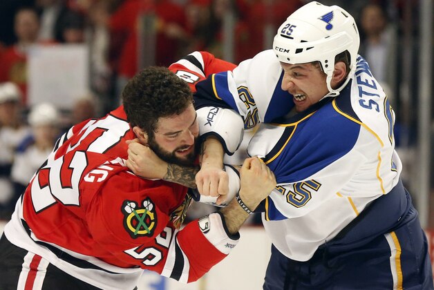 Chicago Blackhawks left wing Brandon Bollig (52) fights St. Louis Blues right wing Chris Stewart during the first period of an NHL hockey game, Tuesday, Jan. 22, 2013, in Chicago. (AP Photo/Charles Rex Arbogast)