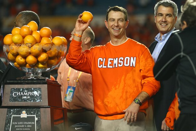 MIAMI GARDENS, FL - JANUARY 03: Head coach Dabo Swinney of the Clemson Tigers holds up an orange after defeating the Ohio State Buckeyes during the Discover Orange Bowl at Sun Life Stadium on January 3, 2014 in Miami Gardens, Florida. Clemson defeated Ohio State 40-35. (Photo by Streeter Lecka/Getty Images)