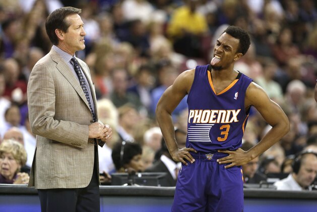 Phoenix Suns head coach Jeff Hornacek watches guard Ish Smith's reaction after a foul call during the first quarter against the Sacramento Kings in an NBA basketball game in Sacramento, Calif., Wednesday, April 16, 2014.  The Suns won 104-99.(AP Photo/Rich Pedroncelli)