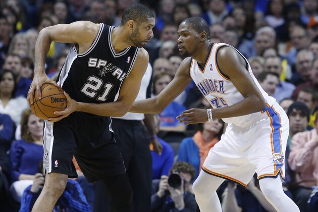 San Antonio Spurs forward Tim Duncan (21) keeps the ball fro Oklahoma City Thunder forward Kevin Durant (35) during an NBA basketball game in Oklahoma City, Thursday, April 4, 2013. (AP Photo/Sue Ogrocki)