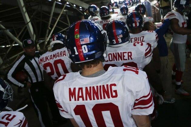 New York Giants quarterback Eli Manning heads out to the field with teammates before playing the San Diego Chargers in an NFL football game Sunday, Dec. 8, 2013, in San Diego. (AP Photo/Gregory Bull)