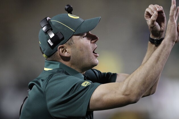 Oregon coach Mark Helfrich calls to his players late in the fourth quarter of Oregon's 57-16 victory over Colorado in an NCAA college football game in Boulder, Colo., on Saturday, Oct. 5, 2013. (AP Photo/David Zalubowski)
