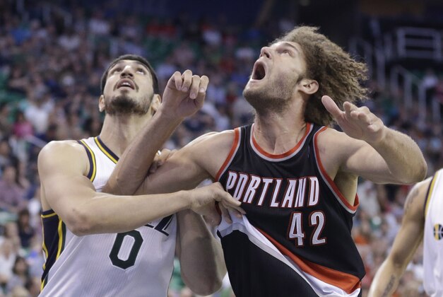 Portland Trail Blazers' Robin Lopez (42) and Utah Jazz's Enes Kanter (0) battle under the boards for a rebound in the second quarter during an NBA basketball game Friday, April 11, 2014, in Salt Lake City. (AP Photo/Rick Bowmer)